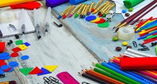 A desk covered with school supplies