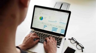 A man looks at Google Analytics on his laptop