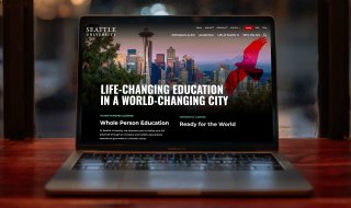 The Seattle University homepage displayed on a laptop