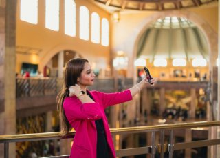 An influencer poses in a library